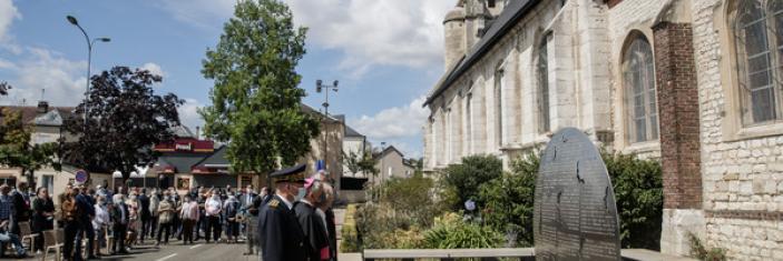 Officiels se recueillant  devant un mémorial devant l'église de Saint-Etienne du Rouvray